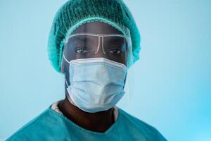 African doctor wearing personal protective equipment fighting against corona virus pandemic - Health care and medical worker concept photo