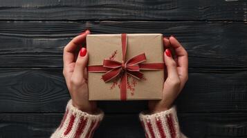 AI generated Female hands are seen holding a gift card and a gift box on a black wooden table photo