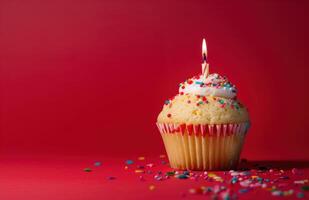 AI generated a cupcake with a single candle on a red background photo