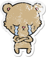 distressed sticker of a crying cartoon bear with folded arms png