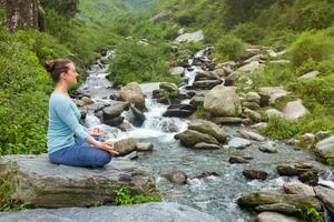 Woman in Padmasana outdoors photo