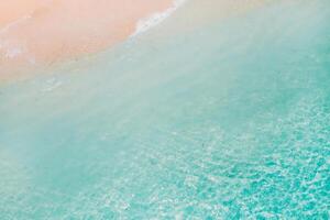 Tropical beach with a bird's eye view of the waves breaking on the tropical Golden sandy beach. Sea waves gently loop along the beautiful sandy beach. photo