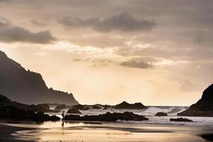 People on the sandy beach of Benijo on the island of Tenerife.Spain photo