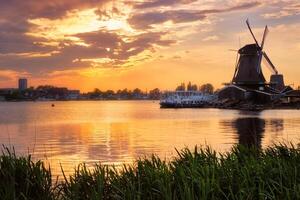 Windmills at Zaanse Schans in Holland on sunset. Zaandam, Nether photo