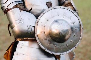 An ancient shield of ancient knight's armor.A medieval concept.Metallic texture photo