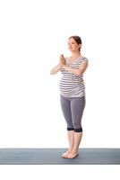 Pregnant woman doing yoga asana Tadasana Mountain pose photo