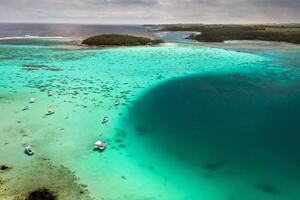 Top view of the Blue Bay lagoon of Mauritius. A boat floats on a turquoise lagoon photo