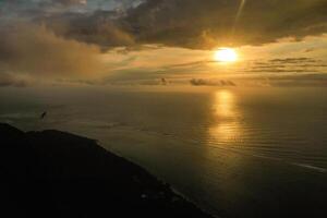 View from the height of the island of Mauritius in the Indian Ocean and the beach of Le Morne-Brabant at sunset photo