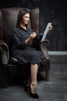 a young brunette female artist stands behind an easel. photo