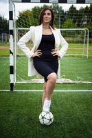 portrait of a beautiful woman football player in a strict office suit. photo