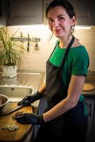 Woman cooking tasty melted chocolate on table in kitchen. photo