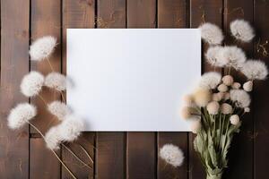 AI generated mockup white blank paper sheet with white fluffy dandelions flowers top view on wooden background, floral template empty card flat lay for design with copy space photo