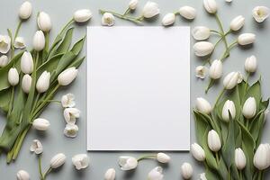 AI generated mockup white blank paper sheet with white tulips flowers top view on light grey background, floral template empty card flat lay for design with copy space photo