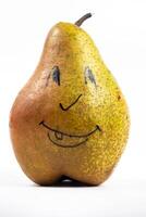 A large pear with a painted smiley face on a white isolated background photo