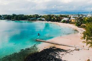 Aerial picture of the east coast of Mauritius Island. Beautiful lagoon of Mauritius Island shot from above. Boat sailing in turquoise lagoon photo