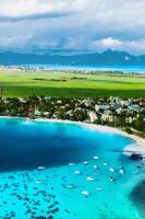 Aerial picture of the east coast of Mauritius Island. Beautiful lagoon of Mauritius Island shot from above. Boat sailing in turquoise lagoon photo