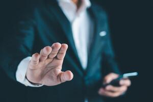 Businessman's hands working using a mobile phone photo