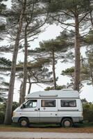 AI generated Camping in the forest of the motorhome . Holidays in a camper van photo