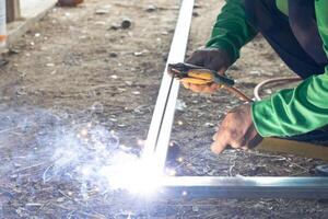 Industrial technicians who weld steel with a large amount of sparks photo