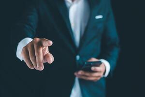 Businessman's hands working using a mobile phone photo