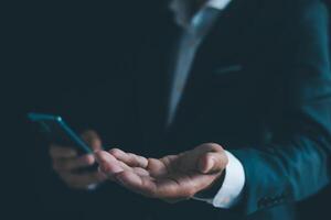 Businessman's hands working using a mobile phone photo