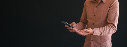 Close-up photo of a man using a mobile phone.