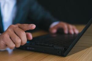 Close-up picture Businessmen work with laptops, chat with mobile phones, and work at office desks. photo