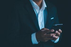 Businessman's hands working using a mobile phone photo