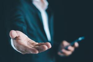 Businessman's hands working using a mobile phone photo