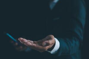 Businessman's hands working using a mobile phone photo