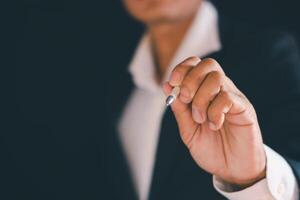 Businessman's hands working using a mobile phone photo