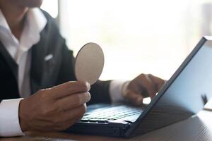 Businessman working with notebook computer in office desk photo