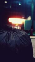 A garbage bag sitting on the ground in front of a building video