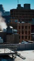 A cityscape view from a rooftop with steam rising in the foreground video