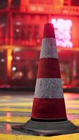 A red and white traffic cone sitting on the side of a road video