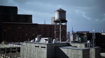 A water tower sits atop a building in the densely populated cityscape video