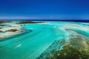 Aerial picture of the east coast of Mauritius Island. Beautiful lagoon of Mauritius Island shot from above. Boat sailing in turquoise lagoon photo