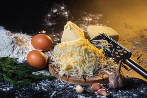 preparation of the process of cooking cheese balls with garlic and dill on a black background photo