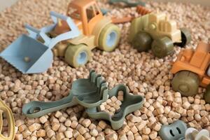 A modern children's sandbox with toys. Sandbox filler in the form of wooden small wooden cubes photo