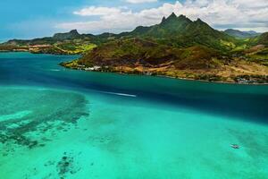 Aerial picture of the east coast of Mauritius Island. Beautiful lagoon of Mauritius Island shot from above. Boat sailing in turquoise lagoon photo