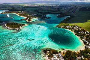 View from the height of the East coast of the island of Mauritius. Flying over the turquoise lagoon and the most beautiful beach of the island of Mauritius in the Belle Mare area photo