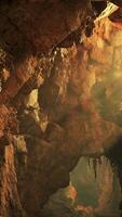 A cave with a stunning natural rock formation and a serene water feature video