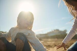 dos adorable pequeño niños muchachas jugando juntos en el playa, edificio arenoso castillo en calentar soleado día foto