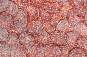 Sausage background texture, pattern from sausage slices photo