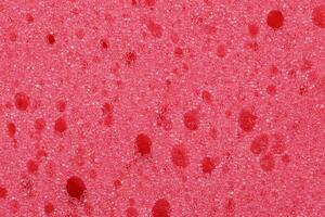 The red texture of the sponge is foam.The background of red foam. photo