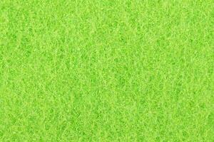 Green texture cellulose foam sponge. Background. photo