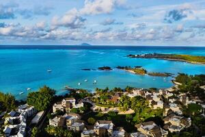 Aerial photography of a coral reef and a hotel complex with beaches in Mauritius, the North-East coast of the island of Mauritius. Beautiful lagoon of the island of Mauritius, taken from above. photo