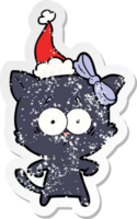 distressed sticker cartoon of a cat wearing santa hat png
