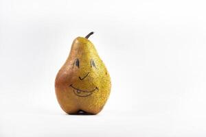 A large pear with a painted smiley face on a white isolated background photo
