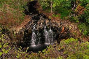 Family on the background of the Rochester waterfall on the island of Mauritius from a height.Waterfall in the jungle of the tropical island of Mauritius photo